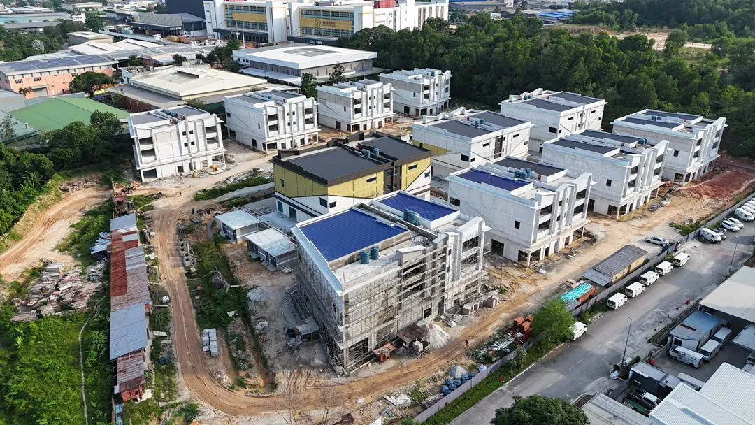 Wide aerial view across the Suria 22 site showing the full block layout